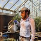 Matt Valle watering in the greenhouse